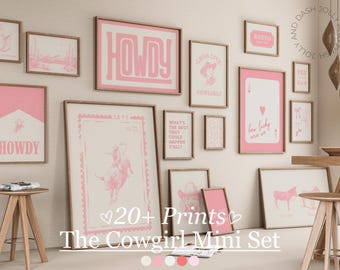 May include: A collection of framed pink and white art prints with a cowgirl theme. The prints feature text like "Howdy" and "Long Live Cowgirls", along with illustrations of a cowgirl and a rodeo scene. The set is called "The Cowgirl Mini Set".
