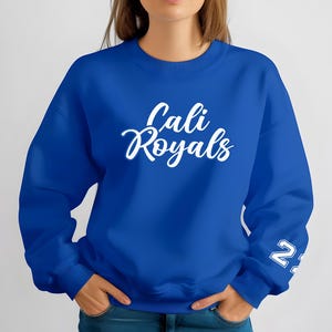 Puede incluir: Sudadera azul real con el texto "Cali Royals" en escritura blanca en el pecho. El n&uacute;mero "22" est&aacute; impreso en blanco en la manga izquierda. La sudadera es de cuello redondo.