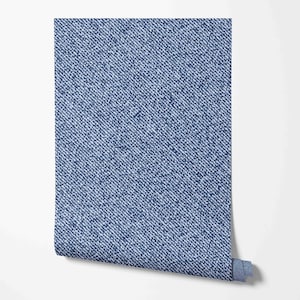 May include: A roll of blue denim-patterned wallpaper. The wallpaper has a subtle white pattern that resembles the weave of denim fabric.