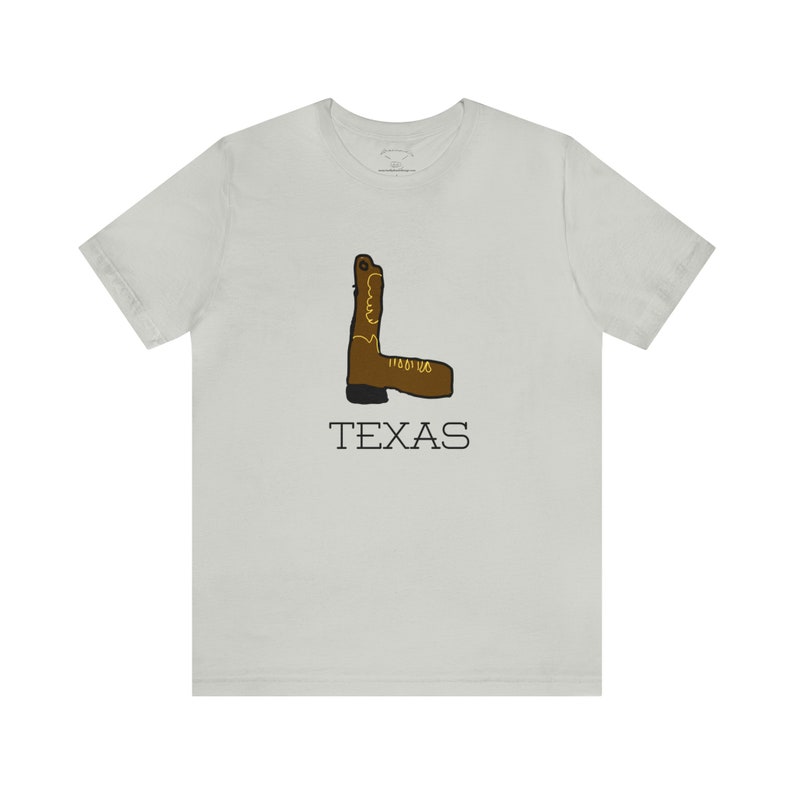 May include: A light gray t-shirt with a brown cowboy boot graphic and the word "TEXAS" printed in black below the boot.