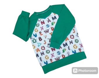 Children's green oeko tex alphabet print shirt.