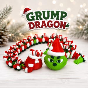 May include: A green dragon figurine wearing a red and white Santa hat, accompanied by a red sack filled with white and red gift boxes. The dragon has a long, segmented body decorated with small gift boxes and the text GRUMP DRAGON above it.