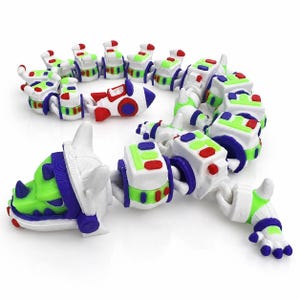 May include: A multi-segmented, articulated toy figure featuring a white, green, and purple color scheme. The head resembles a stylized creature with a pointed horn, while the body consists of interconnected block-like sections and a small rocket.