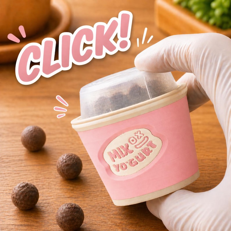 May include: A pink and white yogurt cup with the text "MIX OX YOGURT" and a clear lid. The image also includes several small, round, brown treats and the word "CLICK!" in pink.