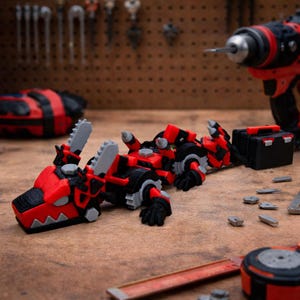 May include: A red, black, and gray toy robot dinosaur with saw blades. The toy is on a wooden surface with tools and a toolbox in the background. The dinosaur has a detailed design.