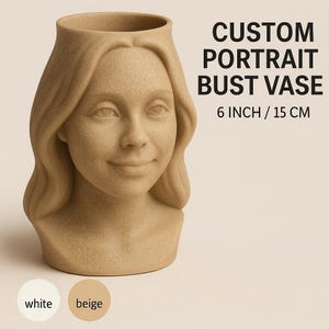 May include: A beige-colored custom portrait bust vase. The vase is in the shape of a person's head and shoulders, with a smiling expression. The text "CUSTOM PORTRAIT BUST VASE" and "6 INCH / 15 CM" are displayed on the right side of the vase. Two color options are shown: white and beige.