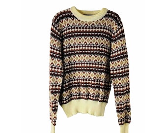 May include: A brown, beige, and white patterned sweater with long sleeves and a crew neck.
