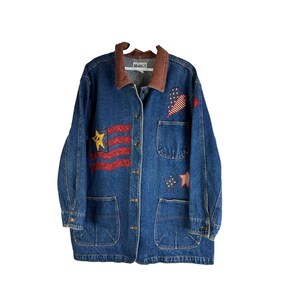 May include: A blue denim jacket with a brown corduroy collar. The jacket has several patches sewn on, including a red, white, and blue American flag, a heart with stars, and stars. The jacket has a button closure and two large pockets on the front.