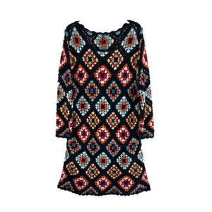 May include: A colorful crochet dress with a geometric pattern in shades of blue, red, orange, green, and white. The dress has long sleeves and a loose fit.