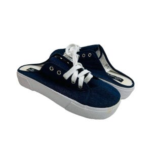 May include: A pair of dark blue canvas slip-on shoes with white laces. The shoes have a white platform sole and a black label on the side that says "DOUBLEROUN D.