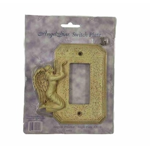 May include: Angel Star switch plate with an angel figure. The switch plate is beige with a textured surface and a kneeling angel on the left side. The packaging reads "Angelic Presence Single Plate #2010."