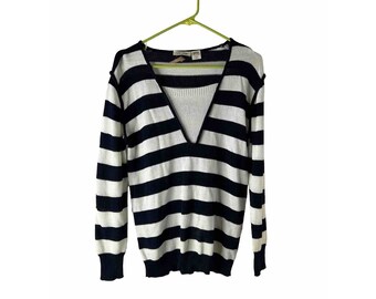 May include: A black and white striped long-sleeved sweater with a deep V-neck.