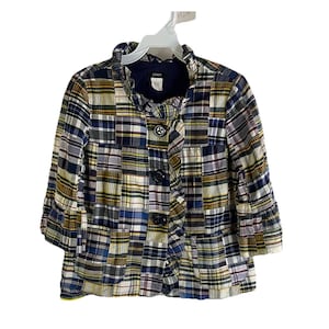 May include: A patchwork plaid jacket with a ruffled collar and three-quarter sleeves. The jacket has a button-up front with three large, dark buttons. The design incorporates various shades of blue, green, yellow, and white.