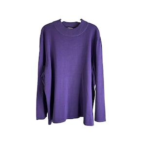 May include: A long-sleeved, purple mock neck sweater.