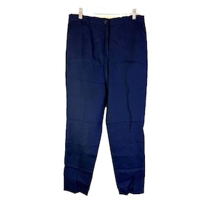 May include: Navy blue pants hanging on a white hanger. The pants have a button and zipper closure, with a classic straight-leg design. The fabric appears to be a solid, dark blue color, suitable for various occasions.