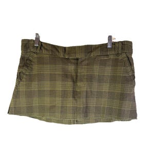 May include: A white ceramic mug with a black handle and the text "But First, Coffee" in a bold, black font. The mug is set against a neutral background, highlighting its simple design.