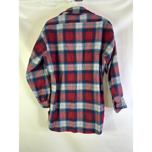 May include: A long-sleeved plaid shirt in red, blue, and white. The shirt has a button-down front and a collared neckline. The plaid pattern is a classic design, suitable for casual wear.