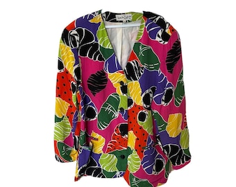 May include: A multi-colored blazer with a floral print featuring pink, green, yellow, red, purple, and black. The blazer has a V-neck and button closure. The label reads "Show the Fashion".