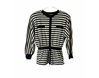 May include: A black and white striped long-sleeve shirt with a button-up front and a cinched waist. The shirt has two pockets with buttons on the chest.