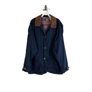 May include: A navy blue corduroy jacket with a brown corduroy collar and a plaid lining. The jacket has a button closure and two pockets.