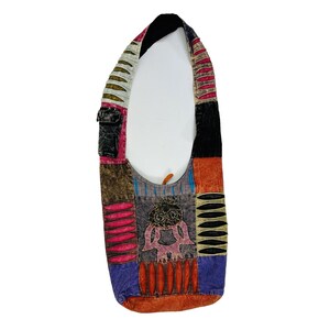 May include: A multi-colored patchwork shoulder bag with a small pocket on the front. The bag is made of different fabrics and has a unique design. The bag is perfect for carrying everyday essentials.