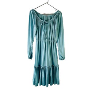 light blue peasant dress Marie-Thrse in Noto Tile  This aqua blue cotton mini dress features a scoop neckline with lace trim and a functional tie detail Size 5 Girls Peasant Dress