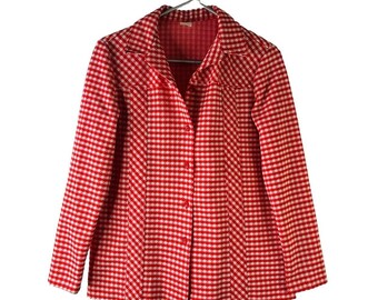 May include: A red and white gingham button-up shirt with a collared neckline and long sleeves.