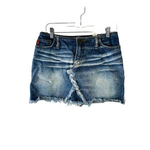 May include: A blue denim skirt with a frayed hem. The skirt has a button and zipper closure and five pockets.