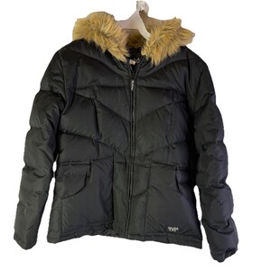 May include: Black puffer jacket with a faux fur-trimmed hood. The jacket has a zip-up front, two front pockets, and a quilted design. The brand name "Mudd" is visible on the lower right side of the jacket.