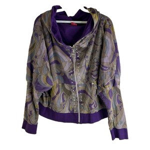 May include: A purple and brown patterned hooded jacket with a zipper closure and a row of silver rhinestones down the front.