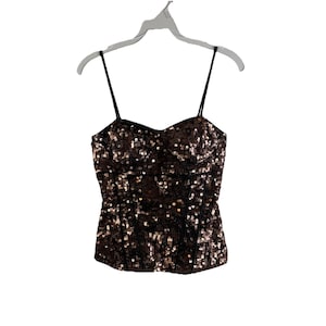 May include: A brown and gold sequined strapless top with a sweetheart neckline and adjustable straps.