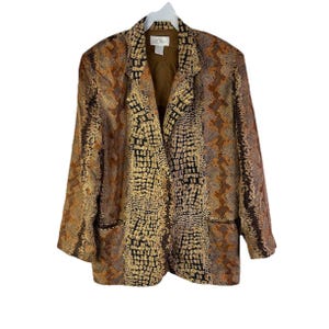 May include: A patterned blazer in shades of brown, tan, and black. The jacket features a notched collar, two front pockets, and a single-button closure. The fabric has a textured, reptile-like pattern.