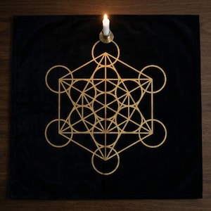 May include: Black velvet altar cloth featuring a gold Metatron's Cube design. A lit white candle sits in a gold candle holder at the top. The geometric pattern is centered on the cloth, creating a symmetrical and spiritual aesthetic.