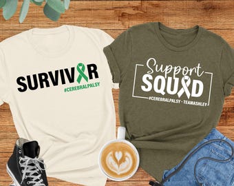 May include: Two t-shirts with a green ribbon design and text. The first shirt is white with the text "SURVIVOR #CEREBRALPALSY". The second shirt is green with the text "Support SQUAD #CEREBRALPALSY-TEAMASHLEY".
