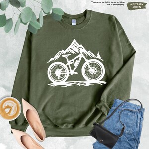 a green sweatshirt with a mountain bike on it