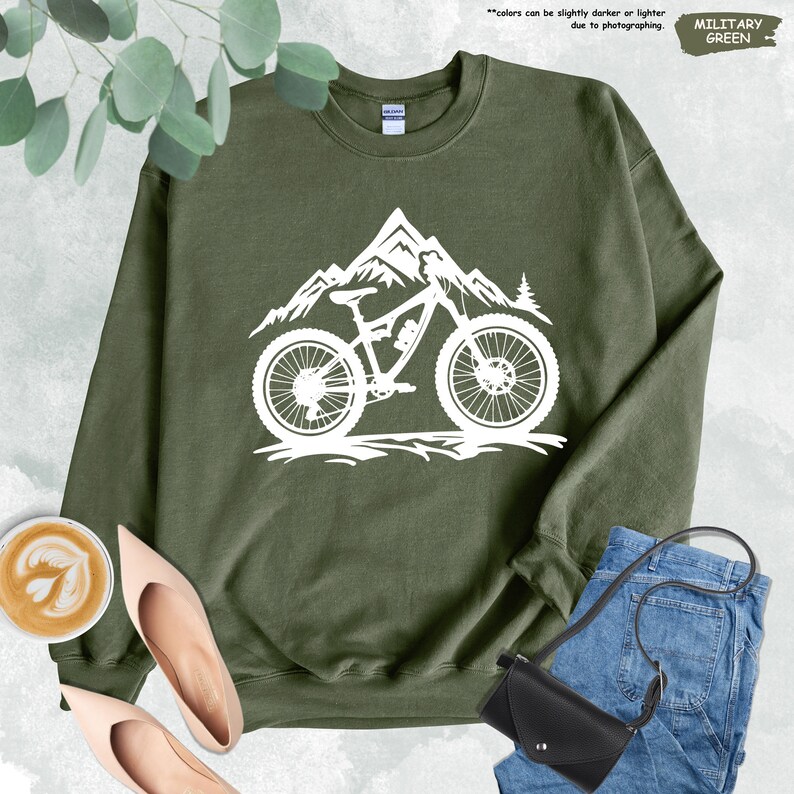 a green sweatshirt with a mountain bike on it