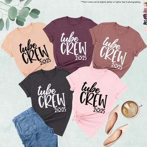 May include: Five different colored t-shirts with the text "tube crew 2025" printed on them in white and black.