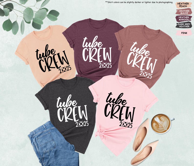 May include: Five different colored t-shirts with the text "tube crew 2025" printed on them in white and black.