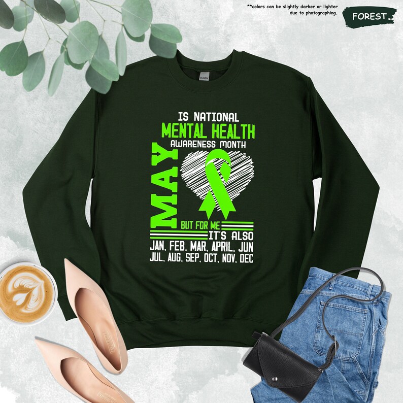 a green sweatshirt with the words mental health awareness month on it