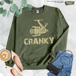 a green sweatshirt with the words cranky printed on it