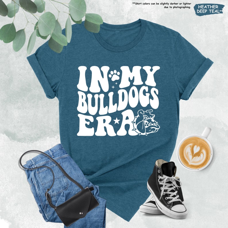 a t - shirt that says in my bulldogs era next to a pair of jeans