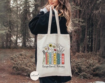 May include: A white canvas tote bag with a floral design and the text "Helping you grow to your full potential" above a stack of colorful books with the text "Occupational Therapy".