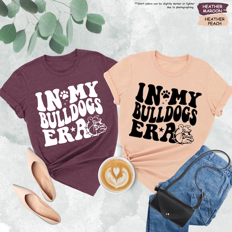 two t - shirts that say in my bulldog's ear and in my bulldog
