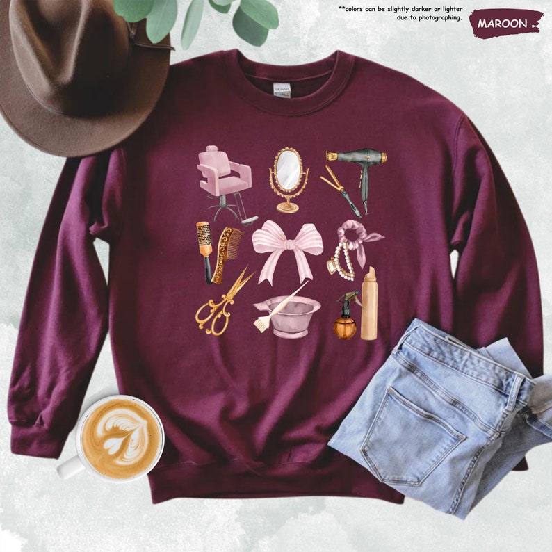 a maroon sweater with a bow, scissors, and other items on it