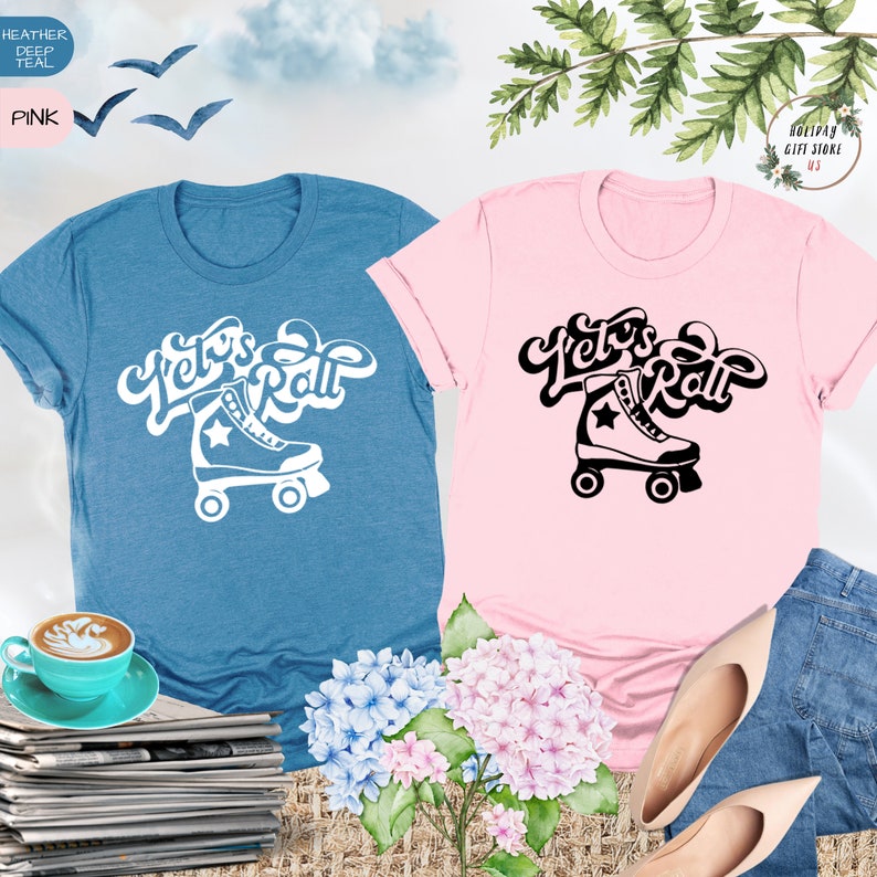 May include: Two t-shirts with the text "Let's Roll" and a roller skate graphic. One shirt is heather deep teal and the other is pink.