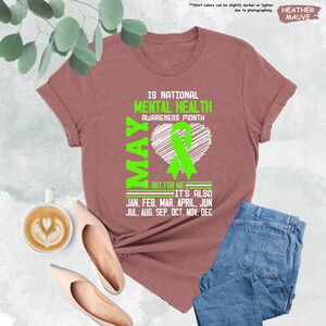 a t - shirt with a green ribbon and a cup of coffee