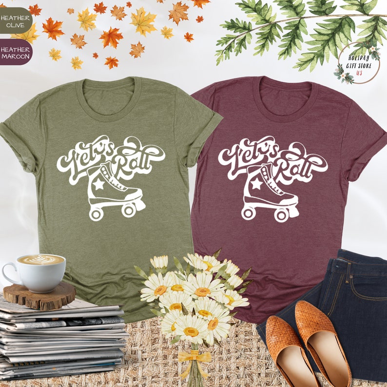 May include: Two t-shirts with the text "Let's Roll" and a roller skate graphic in white. The shirts are in heather olive and heather maroon.