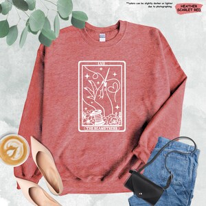 a red sweatshirt with a tarot card design on it