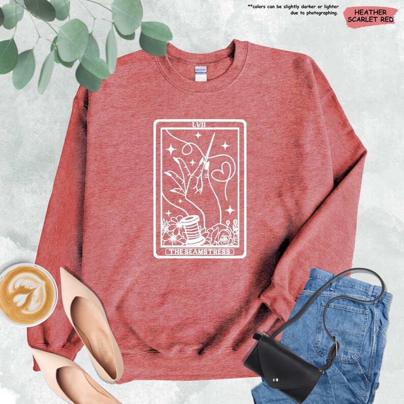 a red sweatshirt with a tarot card design on it