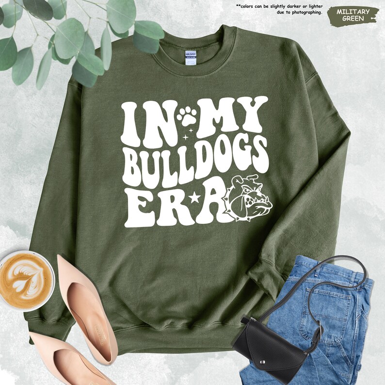 a sweatshirt that says in my bulldog's ear next to a pair of jeans